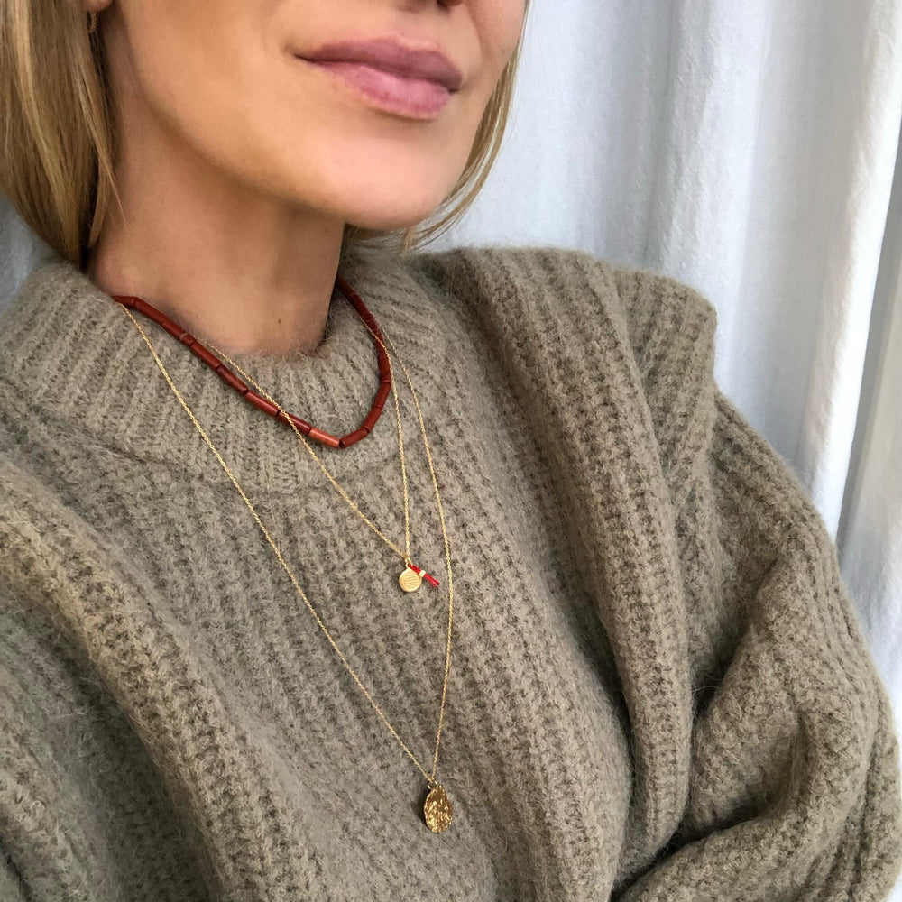 Necklace with a coin and silk thread for good luck