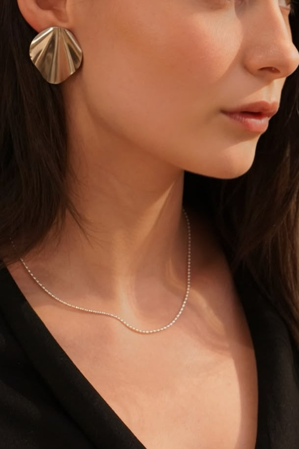 Silver necklace with a small olive bead